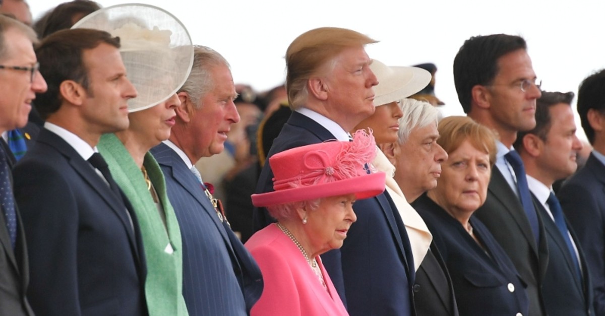 L to R: Franceu2019s Macron, U.K.u2019s May, Prince Charles, Queen Elizabeth II, Donald and Melania Trump, Greeceu2019s Pavlopoulos, Germanyu2019s Merkel, Netherlandu2019s Mark Rutte and Luxembourg's Bettel attend an event to mark 75th anniversary of the D-Day. (AFP)