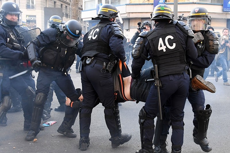 Anti-riot police restrain a protestor during a demonstration against police brutality on Feb. 18, 2017 on the place de la Republique in Paris, France. (AFP Photo)