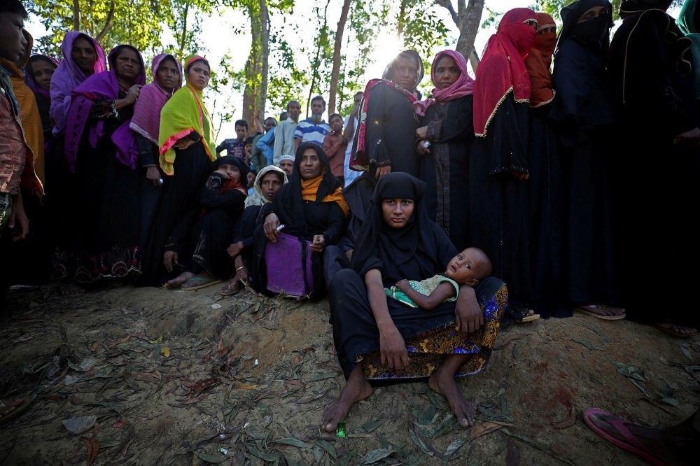 Rohingya refugees line up to receive humanitarian aid at the Kutupalong refugee camp near Cox's Bazar, Bangladesh, Oct. 23.