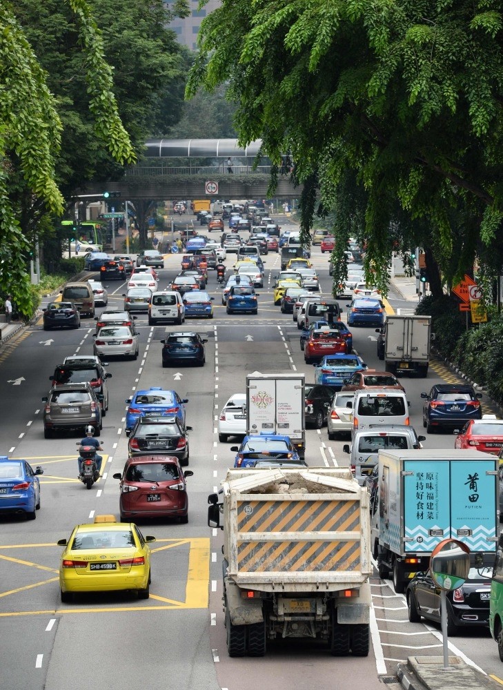 Motorists enter the financial district area in Singapore. The country is one of the most expensive places in the world to buy a vehicle.