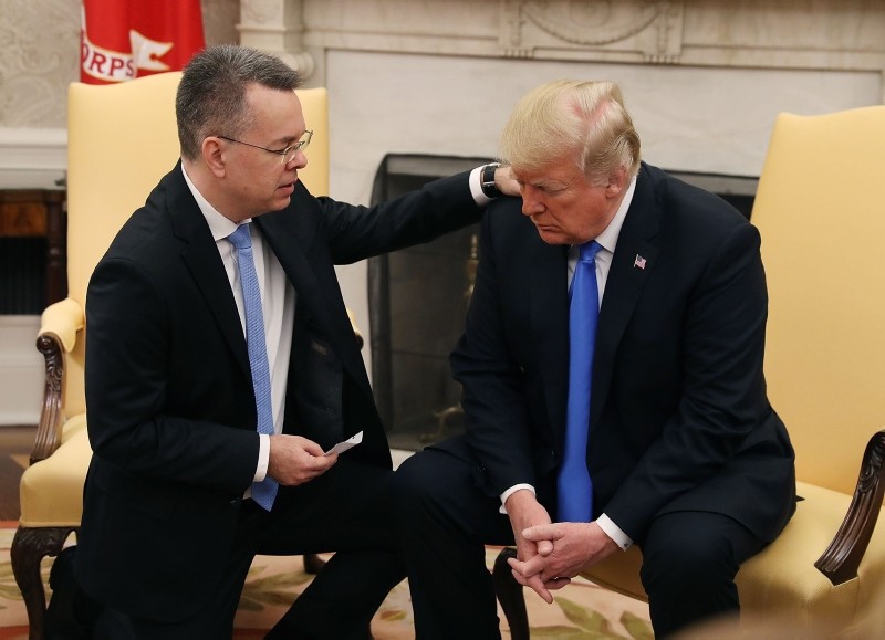 US President Donald Trump prays with American pastor Andrew Brunson in the Oval Office of the White House, Saturday October 13, 2018, in Washington. (AP Photo)
