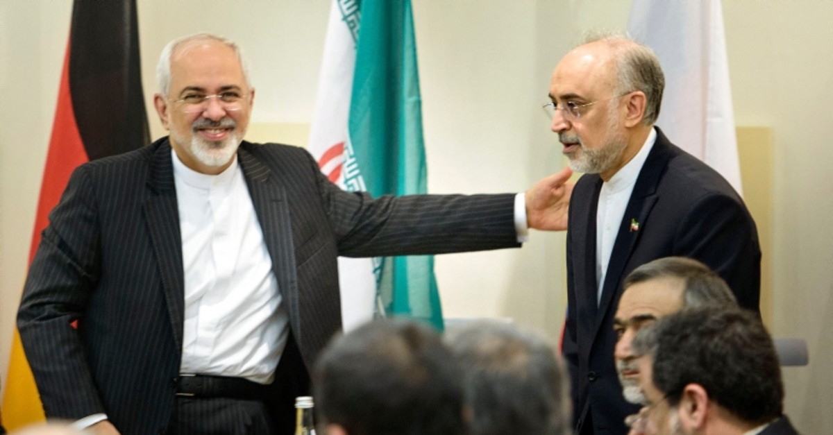 Iranian FM Javad Zarif (L) greets Head of Iranian Atomic Energy Organization Ali Akbar Salehi as he arrives for a meeting with officials from P5+1, the European Union and Iran at the Beau Rivage Palace Hotel in Lausanne March 31, 2015. (Reuters)