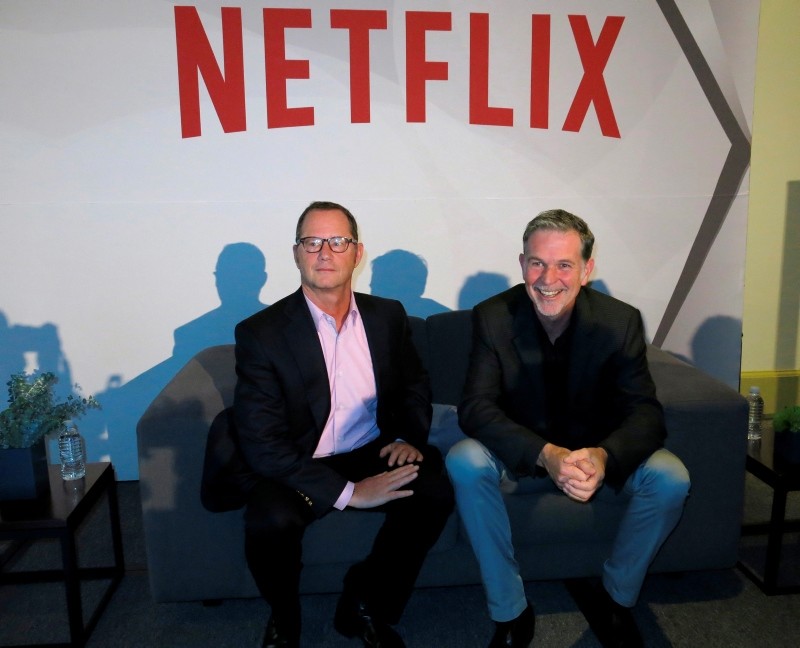 Reed Hastings, CEO and founder of Netflix, right, sits with Jonathan Friedland, global director of communications, as they pose for a portrait during a press conference about their three years of doing business in Latin America. (AP Photo)