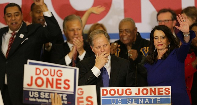 Democratic Alabama U.S. Senate candidate Doug Jones pauses as he addresses supporters while wife Louise (R) acknowledges the audience at the election night party in Birmingham, Alabama, U.S., Dec. 12, 2017. (Reuters Photo)