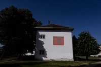 A school, featuring Albanian national flag painted on a side wall in the town of Kamenica on June 13, 2019. 