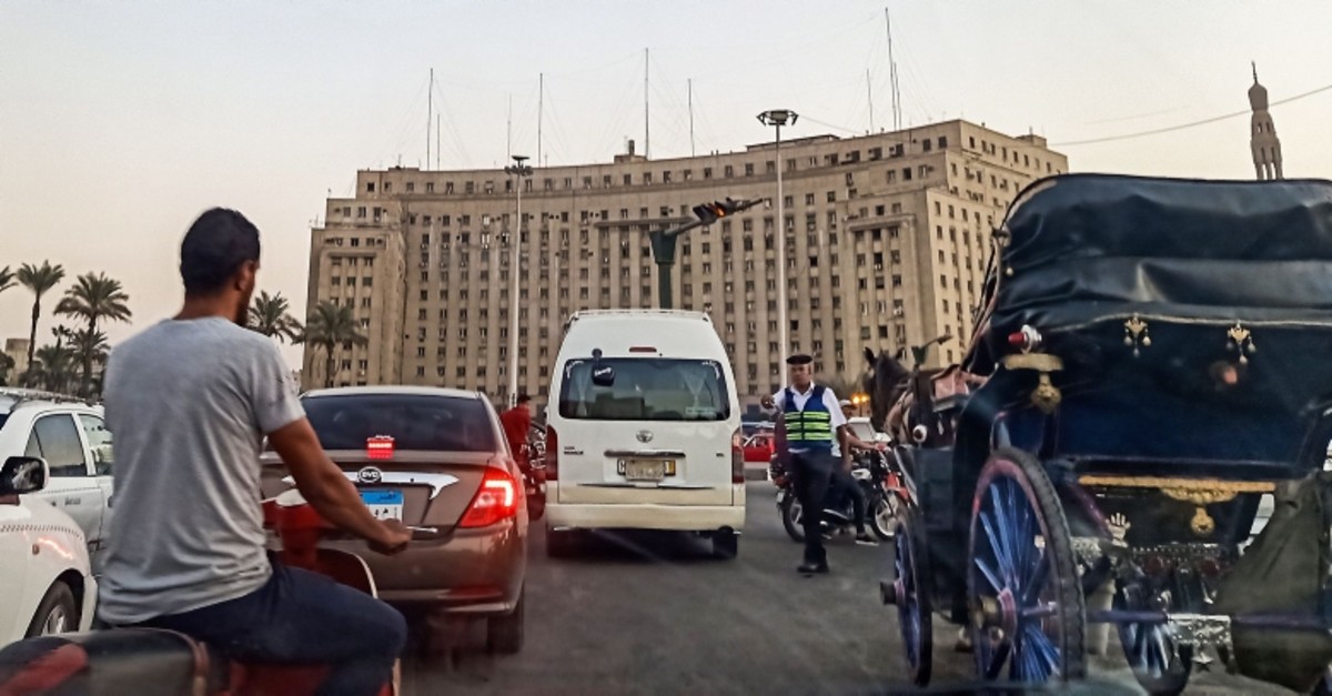 A policeman stops traffic traversing the roundabout in the Egyptian capital Cairo's central Tahrir Square on September 21, 2019 (AFP Photo)