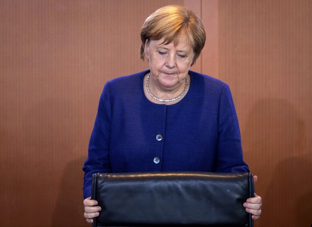 German Chancellor Angela Merkel takes her seat prior to the weekly cabinet meeting, Berlin, Sept. 26.