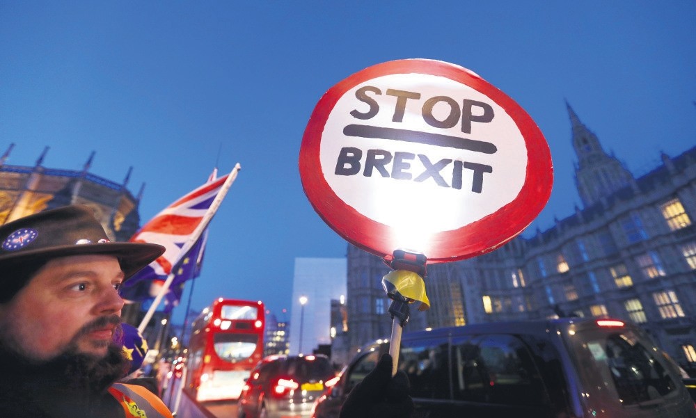A pro-EU demonstrator holds a banner near parliament in London, Jan. 17, 2019.