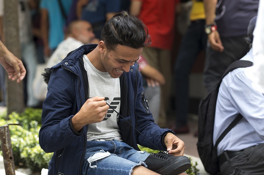 A man smiling after receiving new shoes from the mosque. (AA Photo)