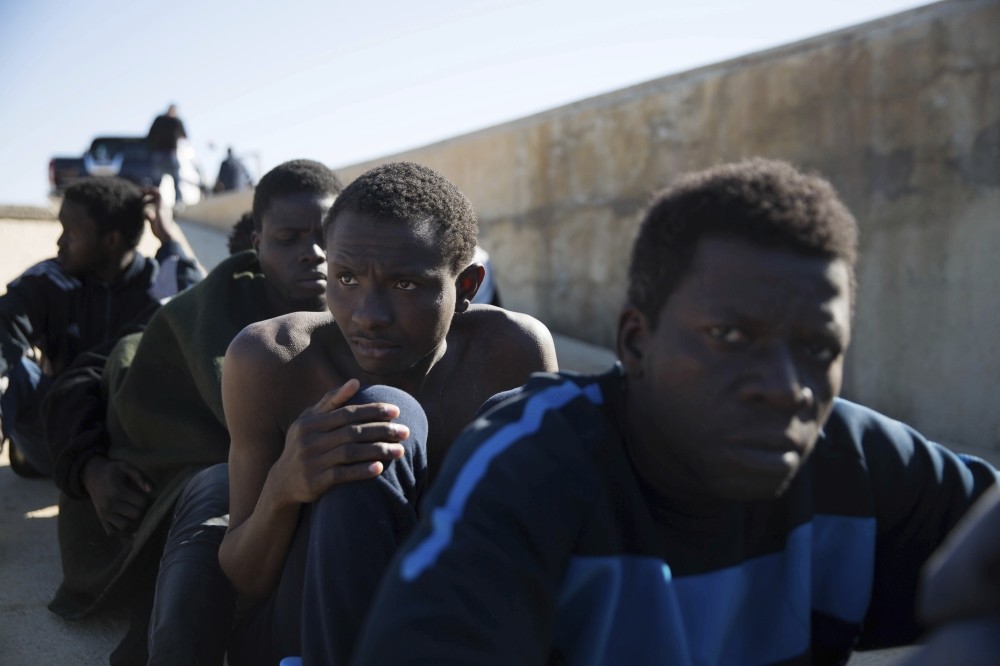 Migrants rest after being rescued by the Coast Guard off the coast of Tripoli, March 3, 2017.