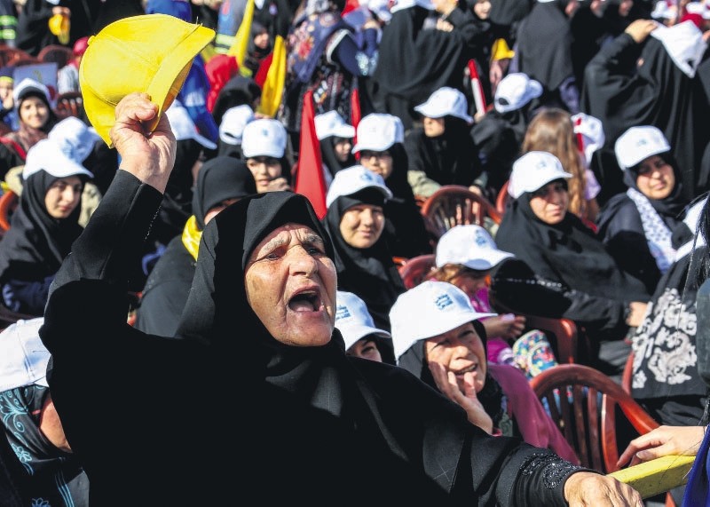 Hezbollah supporters listen to Lebanon's Hezbollah leader Hassan Nasrallah delivering a speech via a big screen during a gathering to commemorate the u201cAl-Quds (Jerusalem) International Dayu201d, Maroun Al-Ras, Lebanese-Israeli border, June 8.