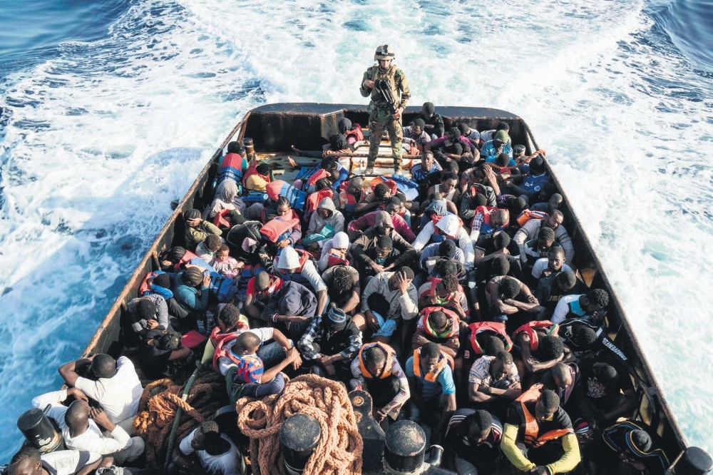 A Libyan coast guardsman stands on a boat during the rescue of migrants attempting to reach Europe off the coastal town of Zawiyah, Libya, June 27.