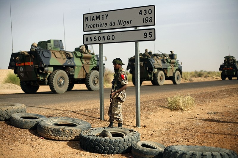 This Feb. 6, 2013, file photo shows French armoured vehicles heading towards the Niger border before making a left turn north in Gao, northern Mali. (AP Photo)