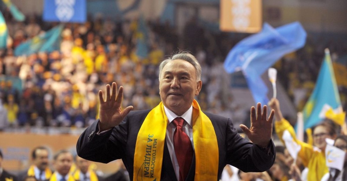 Kazakh President Nursultan Nazarbayev greets his supporters during a celebration rally at a sports center in Astana, April 4, 2011.