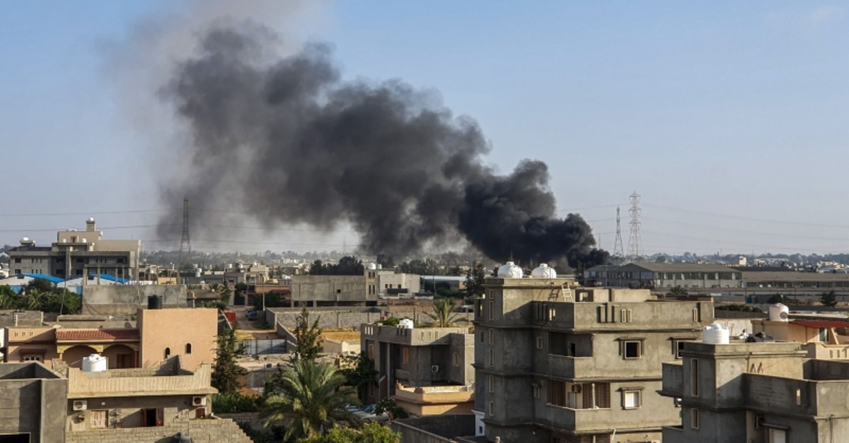 This picture taken on June 29, 2019 shows smoke plumes rising in Tajoura, south of the Libyan capital Tripoli, following a reported airstrike by forces loyal to retired general Khalifa Haftar. (AFP File Photo)