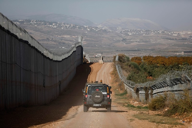 An Israeli army vehicles driving along the border fence between Lebanon (L) and Israel, near Metula, Israel, Nov. 16, 2017. (AFP Photo)