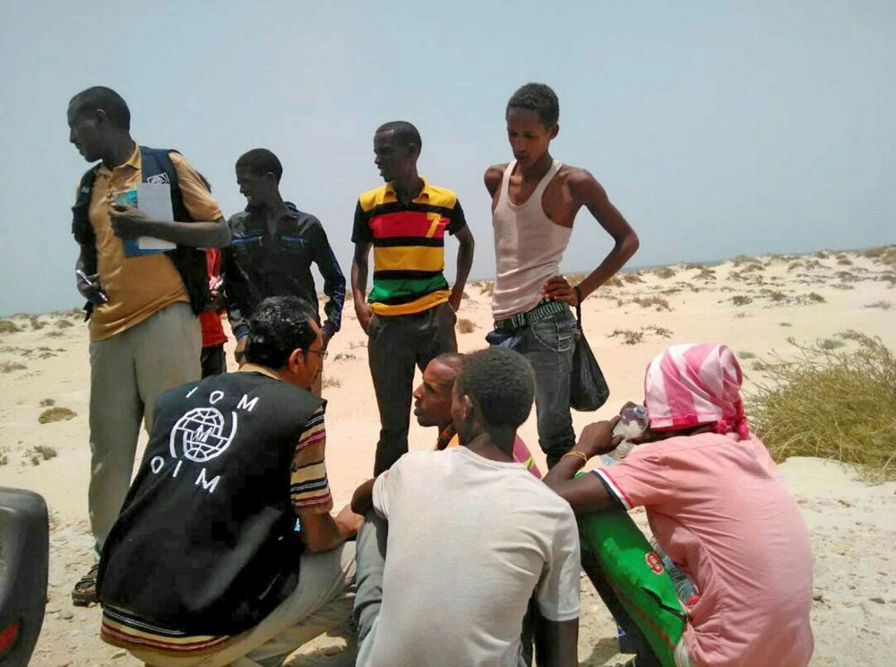IOM staff assist Somali and Ethiopian migrants who were reportedly forced into the sea by smugglers, on a beach in Shabwa, Yemen, Aug. 10.