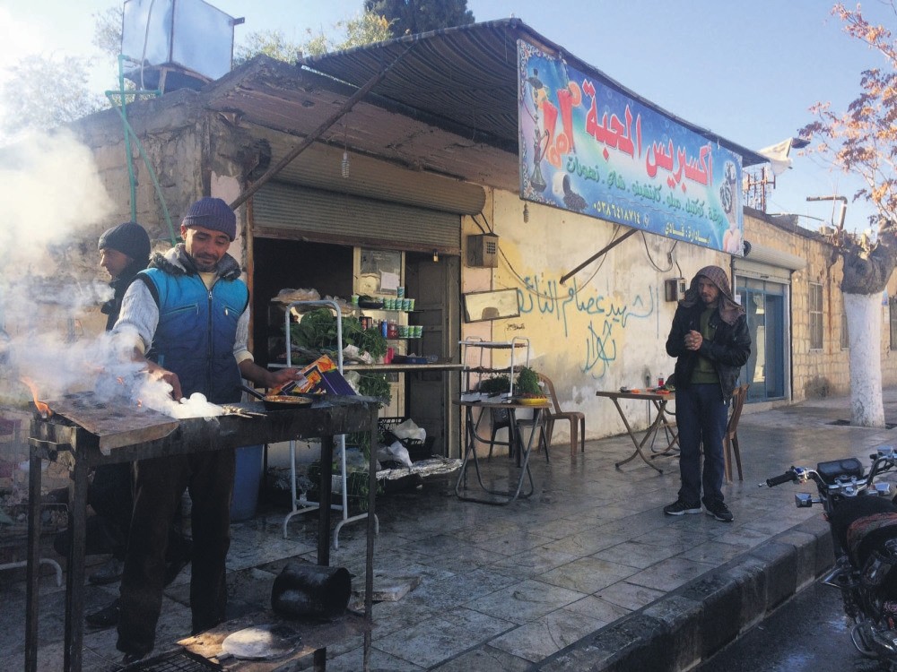 A Syrian man cooks and sells kabap in a street of post-war Jarablus, Syria.