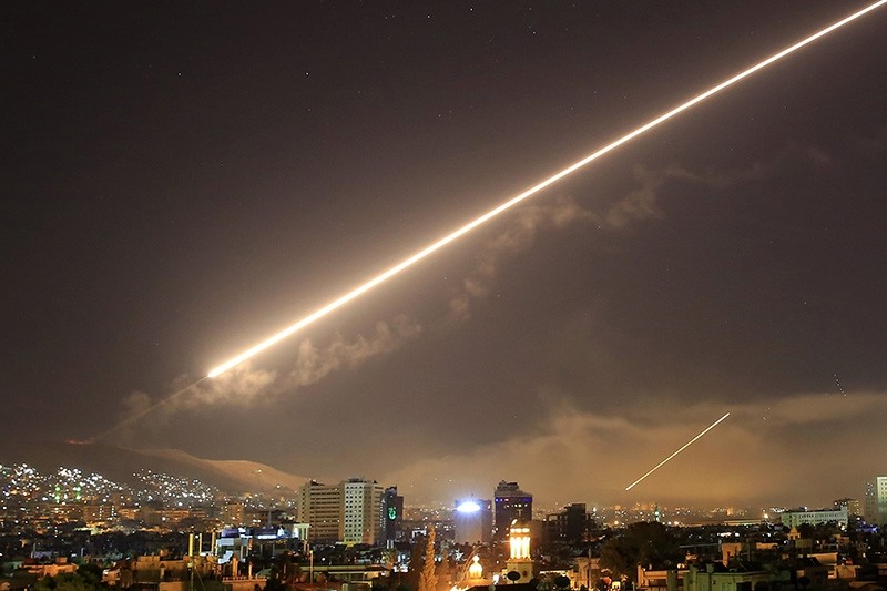 Damascus skies erupt with surface to air missile fire as the U.S. launches an attack on Syria targeting different parts of the Syrian capital Damascus, Syria, early Saturday, April 14, 2018. (AP Photo)