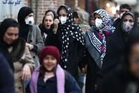 Iranian women wearing protective masks to prevent contracting a coronavirus walk at Grand Bazaar in Tehran, Iran Feb. 20, 2020. (West Asia News Agency/Nazanin Tabatabaee via Reuters)
