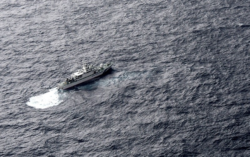 In this aerial photo, Japan's Coast Guard ship is seen at sea during a search operation for U.S. Marine refueling plane and fighter jet off Muroto, Kochi prefecture, southwestern Japan, Thursday, Dec. 6, 2018. (AP Photo)