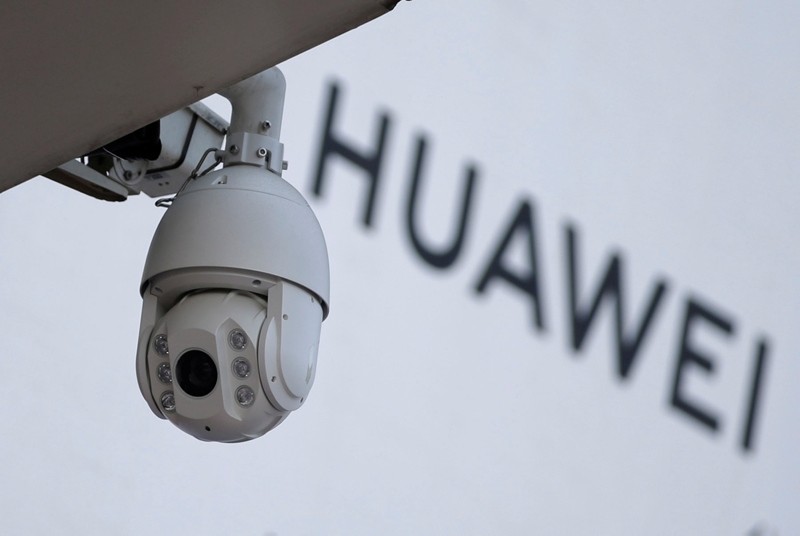 A surveillance camera is seen next to a sign of Huawei outside a shopping mall in Beijing, China January 29, 2019. (Reuters Photo)
