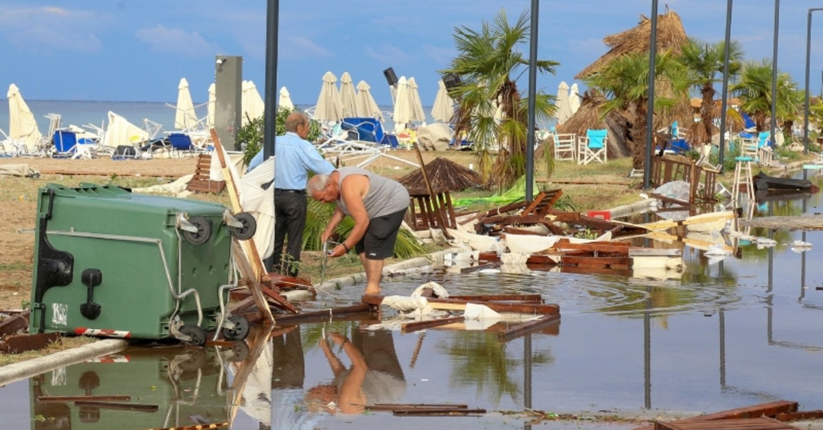Two men search in debris after a storm at Nea Plagia village in Halkidiki region, northern Greece on Thursday, July 11, 2019. (AP Photo)