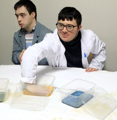 Boy with Down syndrome dips a hand in the natural paint. (AA Photo)