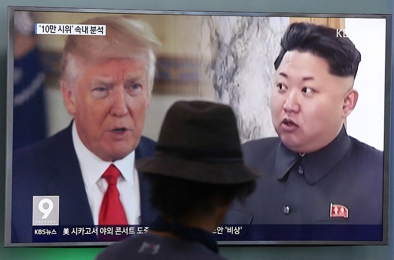 In this Aug. 10, 2017, file photo, a man watches a television screen showing U.S. President Donald Trump and North Korean leader Kim Jong Un during a news program at the Seoul Train Station in Seoul, South Korea. (AP Photo)