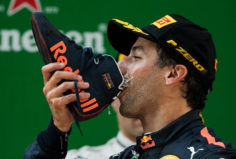 Red Bull's Australian driver Daniel Ricciardo drinks champagne out of his shoe as he celebrates on the podium after winning the Formula One Chinese Grand Prix in Shanghai, China, April 15, 2018. (AFP Photo)