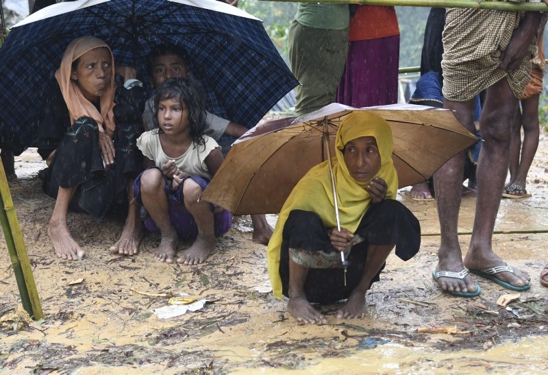 In this file photo taken on September 17, 2017 Rohingya refugees protect themselves from rain in Balukhali refugee camp near the Bangladesh town of Gumdhum (AFP File Photo)