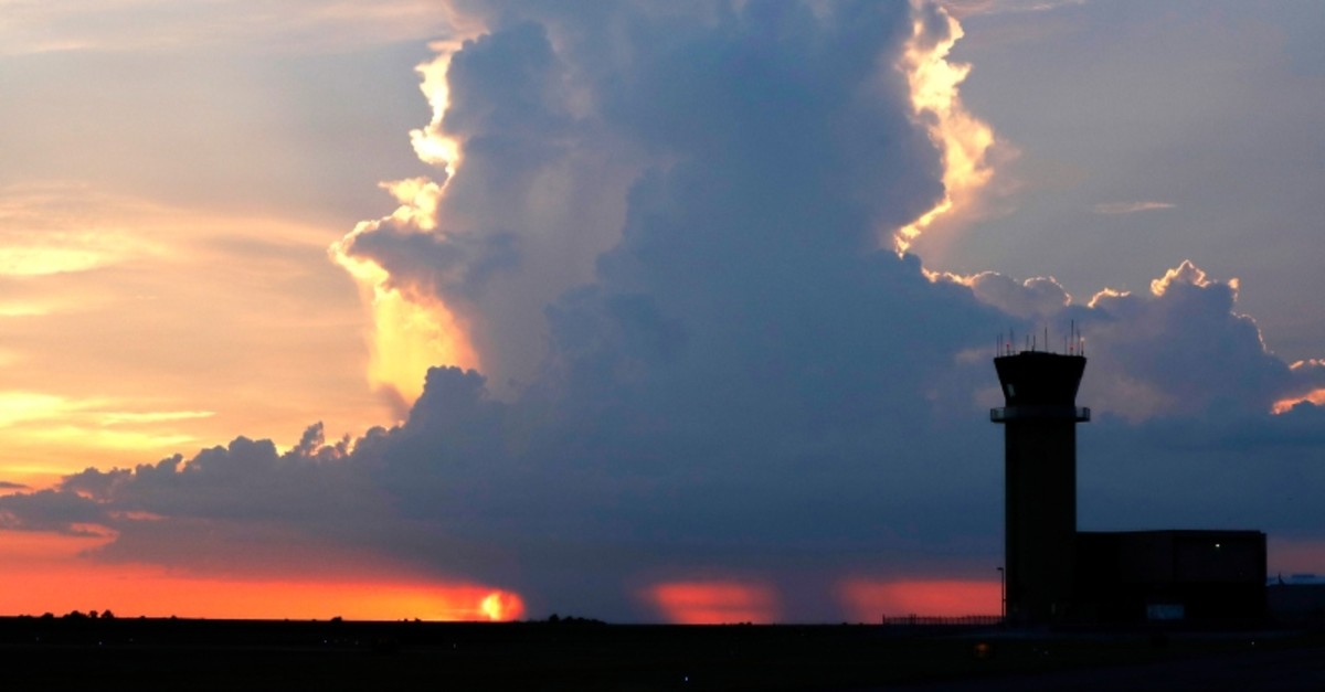 In this July 15, 2018 photo, the New Orleans Lakefront Airport air traffic control tower is seen in front of a sunset and a rain cloud over Lake Pontchartrain, in New Orleans (AP Photo)