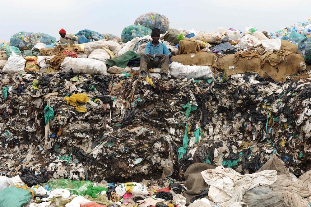 A man sits on waste at the Ngong town dumping site, 30 kilometers southwest of Nairobi.