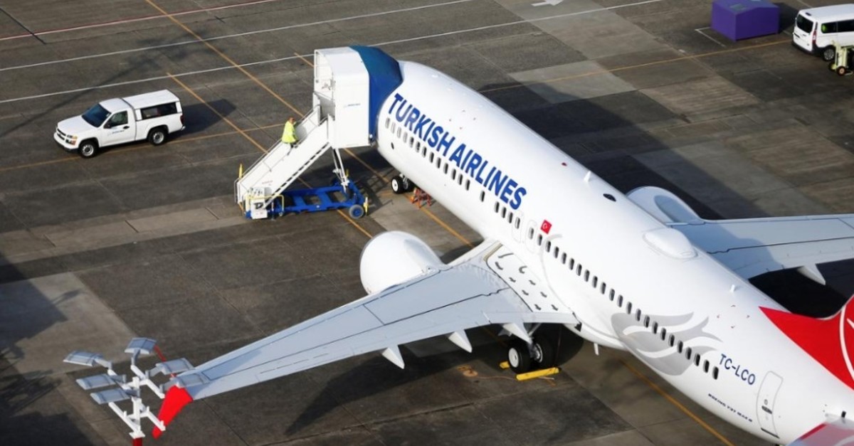 An aerial photo shows a worker climbing up to a Turkish Airlines Boeing 737 MAX airplane grounded at Boeing Field in Seattle, Washington, March 21, 2019. (Reuters Photo)