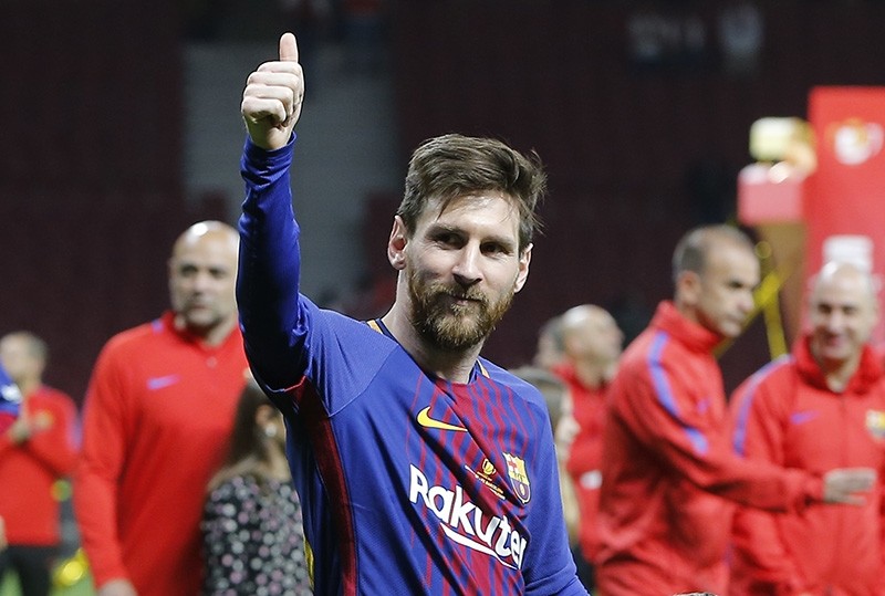 Barcelona's Lionel Messi celebrates during an award ceremony after defeating Sevilla 5-0 in the Copa del Rey final soccer match at the Wanda Metropolitano stadium in Madrid, Spain (AP Photo)