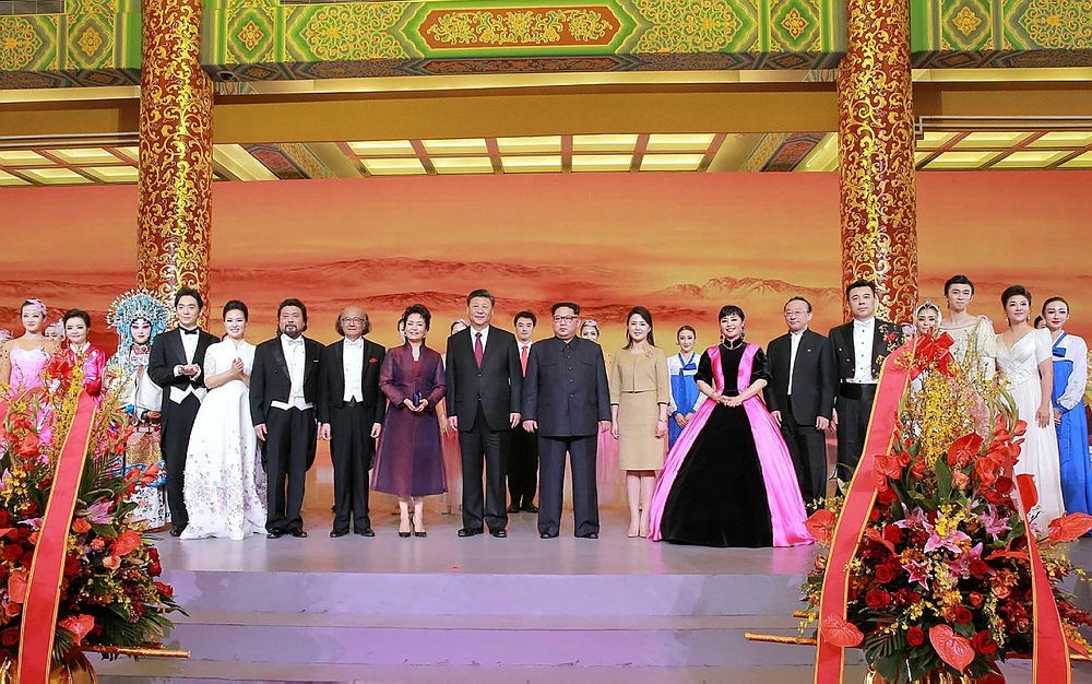 This picture from North Korea's official Korean Central News Agency (KCNA) taken on March 26, 2018 and released on March 28, 2018 shows China's President Xi Jinping (centre L), his wife Peng Liyuan (8th L), North Korean leader Kim Jong Un (centre R) and his wife Ri Sol Ju (9th R) at the Great Hall of the People in Beijing.