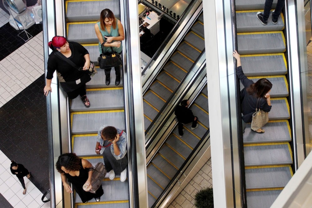 Shoppers ride escalators at the Beverly Center mall in Los Angeles, California, U.S., Nov. 8, 2013.