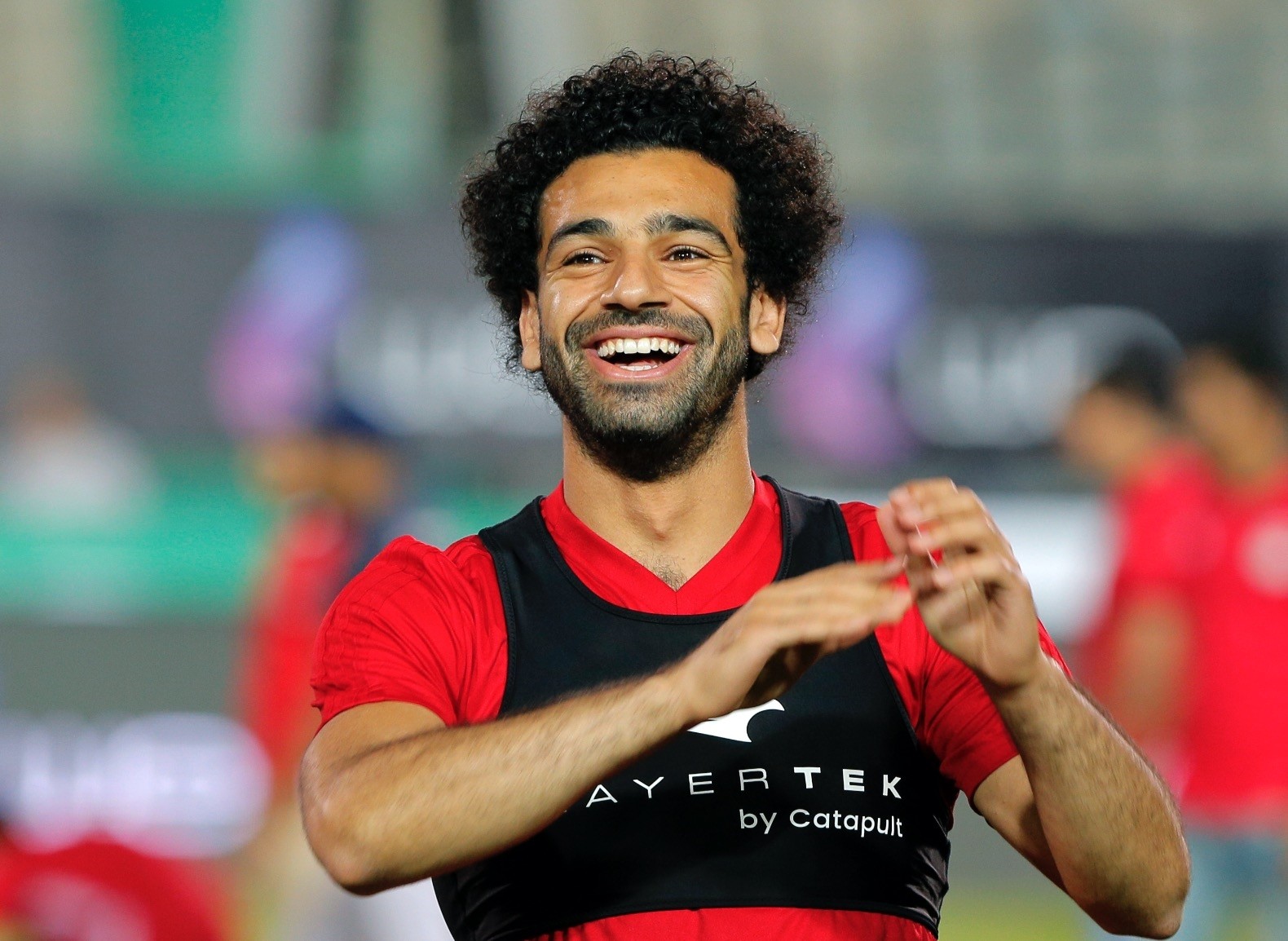 Egyptian national team player and Liverpoolu2019s star striker Mohammed Salah smiles as he greets fans during the final training of the national team at Cairo Stadium June 9.