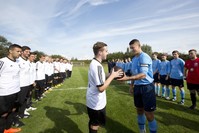 The team captains of Britain's Newark Town FC and Germany's FC Emmendingen exchange a football prior to a re-creation of the World War I Christmas Truce football match in Messines, Belgium.