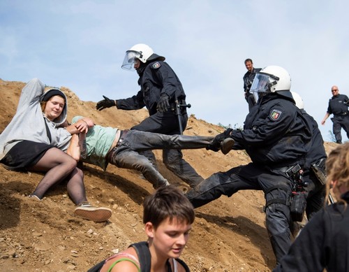 Protesters who try to enter the Hambach forest are stopped by the police in Kerpen, Germany, Sunday, Sept. 16, 2018. (AP Photo)