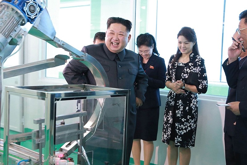 This picture released from Korean Central News Agency (KCNA) on Oct. 29, 2017 shows North Korean leader Kim Jong Un inspecting the Pyongyang Cosmetics Factory, as his wife Ri Sol-ju (2nd R) looks on. (Photos from AFP)