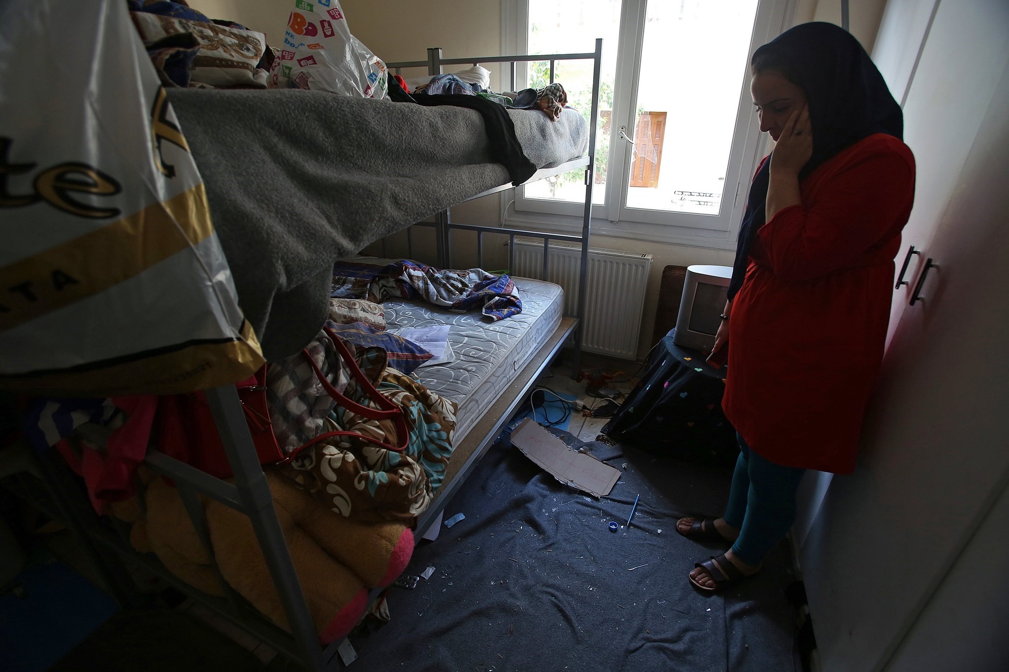 Mother of 11-years-old Afghan boy Amir stands inside her children's bedroom after an attack by unknown individuals in Athens, Greece, 03 November 2017. (EPA Photo)