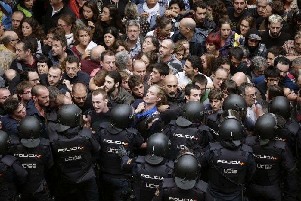 Spanish riot police form a security cordon around the Ramon Llull school in Barcelona, Catalonia, Spain, Oct. 1.