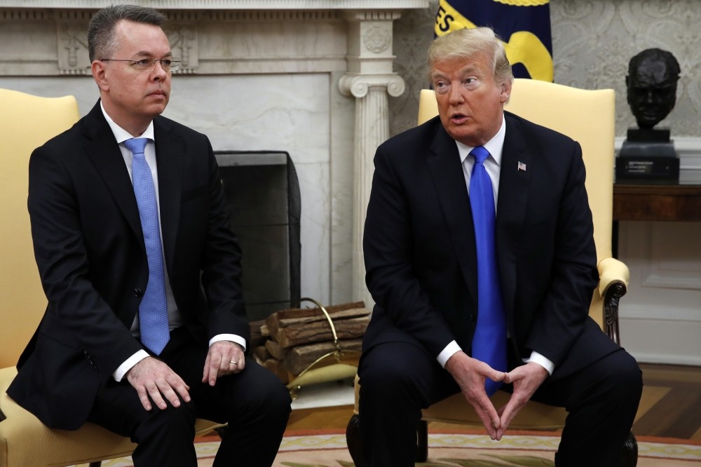 U.S. President Donald Trump meets with American pastor Andrew Brunson, (L), in the Oval Office of the White House, Oct. 13.