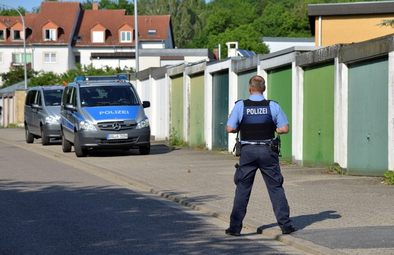 A policeman stands near the house where a shooting took place, in Saarbruecken, Germany, Saturday, May 19, 2018. (AP Photo)