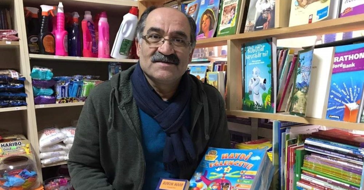Kamber Bozan poses with books in his grocery store, Istanbul, Jan. 8, 2020. (?HA Photo) 