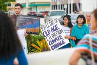 Supporters carry signs during a rally, hosted by the Micronesia Climate Change Alliance, to raise awareness of issues affect global climate change, in front of the Guam Congress Building in Hag  t  a on Wednesday, Aug. 7, 2019. (Reuters Photo)