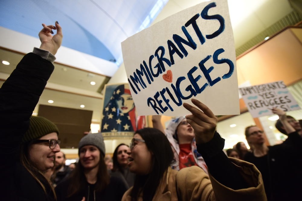 Protesters hold signs as they block a road during a demonstration against the immigration ban at Los Angeles International Airport.
