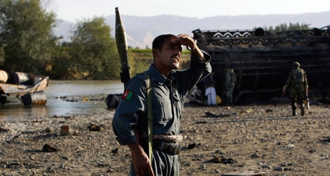 In this Saturday, Sept. 5, 2009 file photo Afghan police inspect the site where villagers reportedly died when American jets bombed fuel tankers hijacked by the Taliban, outside Kunduz, Afghanistan. (AP Photo)