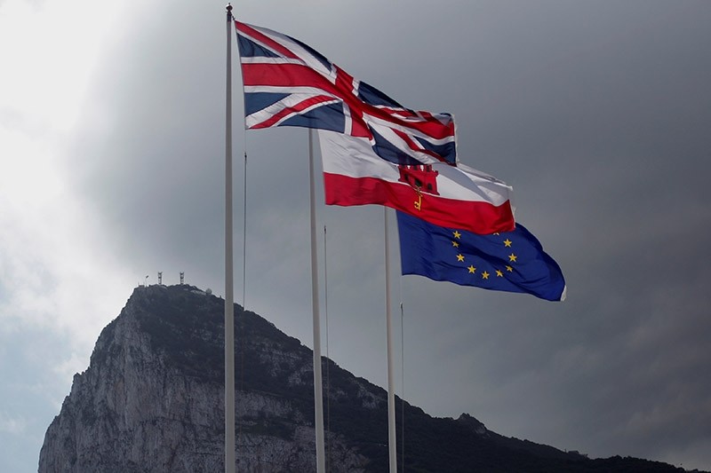 The Union Jack (L), the Gibraltarian flag (C) and the EU flag are seen flying, at the border of Gibraltar with Spain, in front of the Rock in the British overseas territory of Gibraltar, historically claimed by Spain April 3, 2017. (Reuters Photo)